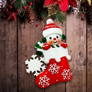 Resin snowman in Christmas stocking hanging decoration with festive pine background