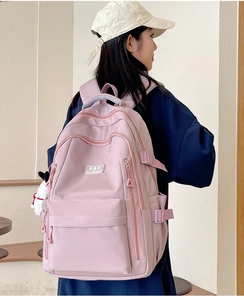 Side view of a pink school backpack for students with adjustable side buckles and durable fabric
