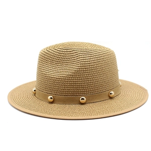 Detailed close-up of straw boater hat with metallic studs on the decorative band