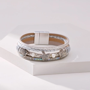 Detail view of multi-layer ocean bracelet with starfish, turtle charms and magnetic clasp