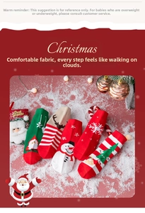 Flat lay of five pairs of Christmas themed cotton socks on snow with festive decor