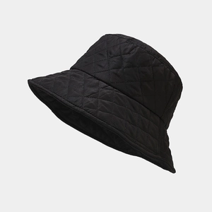 Detailed close-up of a black quilted fisherman hat with a classic diamond pattern texture