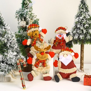 Detail of plush Christmas tree ornaments featuring Santa, Snowman, Reindeer, and Bear dolls