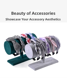 Velvet T-bar stand displaying knotted fabric headbands in stripes, plaids and floral prints