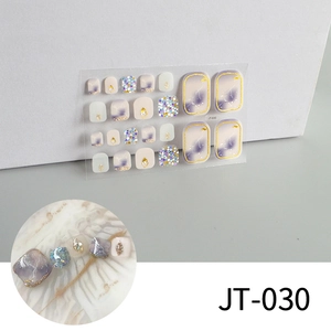 Detailed sheet of 3D gold-stamped toe nail stickers with purple marble and glitter patterns