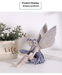 Close-up of resin flower fairy figurine with purple wings and a small petal storage tray