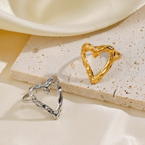 Irregular textured heart open rings in gold and silver finishes on elegant white satin