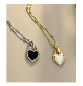 Detail of S925 sterling silver heart pendants with mother of pearl and beaded borders
