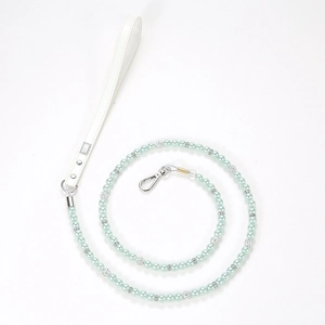 Detail of mint green pearl pet leash with white leather handle and silver metal clasp