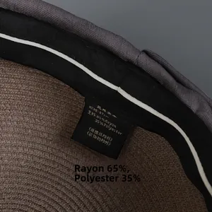 Detail view of straw hat interior with sweatband and 57cm size material label