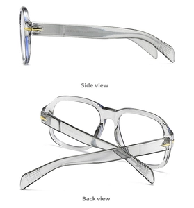 Detail view of modern grey square glasses with gold arrow accents and metallic hinges