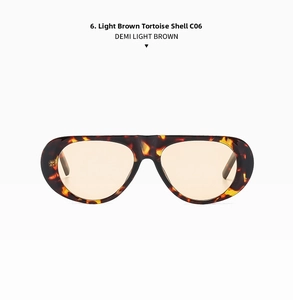 Detail view of oval demi light brown sunglasses with tortoise texture and tinted lenses