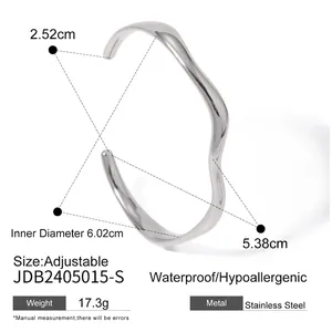 Polished wavy stainless steel open bangle with waterproof and hypoallergenic features