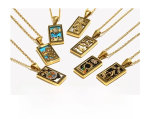 Detail of 18K gold-plated stainless steel tarot pendants featuring sun and moon designs