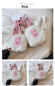 Detailed close-up of pink shoulder straps and canvas material on cartoon bear backpack