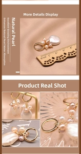 Detail view of large baroque pearl earrings with golden rings and size measurement scale