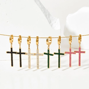 Detailed view of punk style cross earrings with colorful rhinestones in gold plating