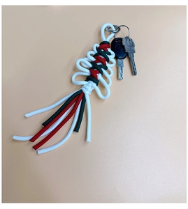 Macro detail of handmade paracord Christmas keychain with red and green woven knot