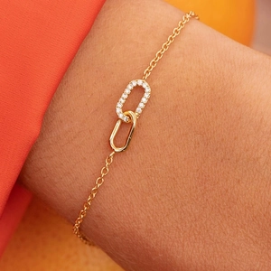 Close-up of a gold 925 silver bracelet with interlocking zircon-set oval links