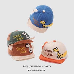 Detail view of cotton baby baseball caps with 3D dinosaur embroidery in four colors
