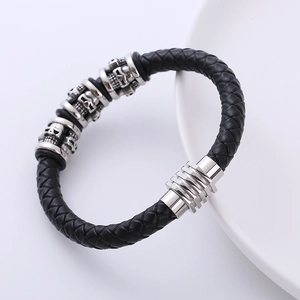 Men's braided leather bracelet with silver stainless steel skull charm on white background