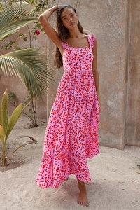 Detailed view of tiered bohemian maxi dress with pink abstract print and ruffle straps