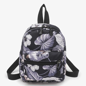Minimalist canvas backpack with tropical floral pattern and dual zipper compartments