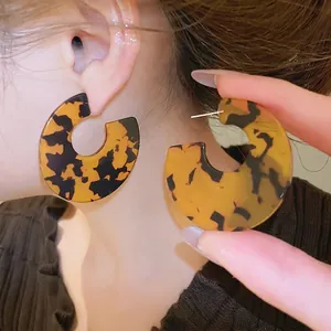 Tortoise shell acrylic C-shape hoop earrings with silver pins for a minimalist vintage style