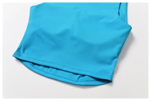 Close-up detail of double-stitched hem and elastic fabric on blue sports vest