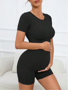 Close-up of black ribbed seamless maternity sports set with high stretch knit fabric