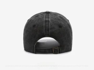 Detail view of the washed denim baseball cap featuring an adjustable metal buckle strap