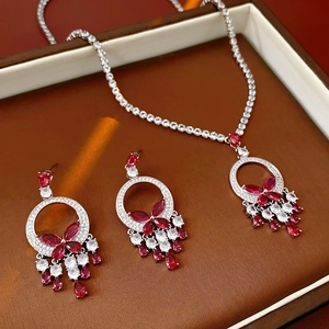 Close-up of zircon butterfly pendant and earrings set in a premium jewelry gift box