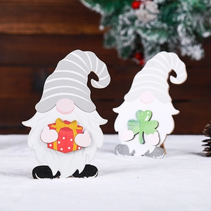 Wooden gnome holiday decorations with striped hats holding gift box and four-leaf clover