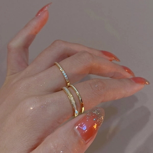 Detail of double-layer gold plated ring set with zircon and white shell on model