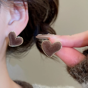 Detail of brown flocked heart stud earrings with elegant gold trim for women