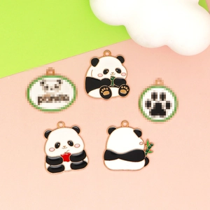 Enamel panda pendants in various colors on pink and green background for DIY jewelry