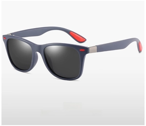 Detail view of square navy matte sunglasses with polarized lenses and red inner temple accents