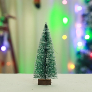 Close-up of mini snowy Christmas tree with pine needles and a natural wood base