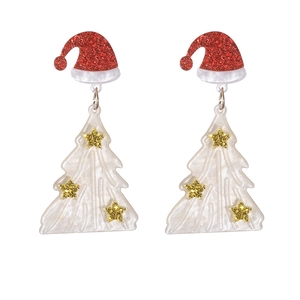 Detail of Christmas tree earrings with golden stars and red Santa hat decorations