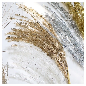 Close-up of sparkling gold, silver and white sequined stems for Christmas tree decoration