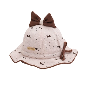 Baby autumn beige bucket hat with brown polka dots and large bow tie decoration
