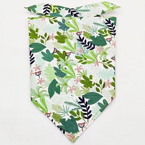 Close-up of tropical leaf pattern and yellow stitching on this cotton pet bandana