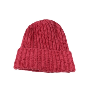 Deep pink oversized knitted beanie for women featuring a thick ribbed texture and rolled edge