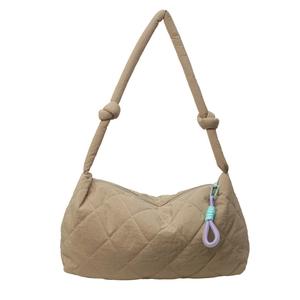 Quilted large khaki tote bag with colorful braided charm and knotted shoulder strap