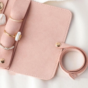 Macro detail of pink microfiber jewelry roll showing soft texture and ring holder feature