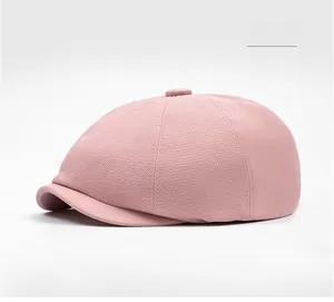 Detail view of pink newsboy cap showing twill fabric texture and stitched paneled crown