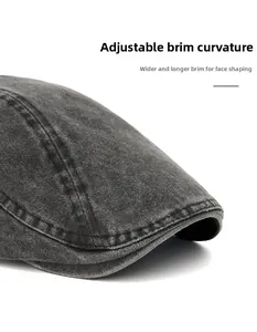 Detail of washed denim flat cap showing wide foldable brim and vintage stitching textures