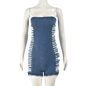 Détail d'un combishort en jean bleu avec découpes latérales et ourlet effiloché usé