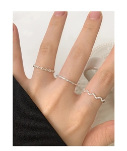 Close-up of minimalist S925 sterling silver twist wave rings set for women
