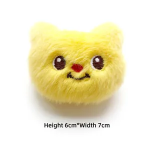 Close-up of yellow plush bear charm showing 6cm height and 7cm width dimensions